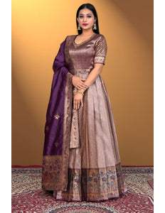 Woman wearing a traditional outfit with a purple dupatta