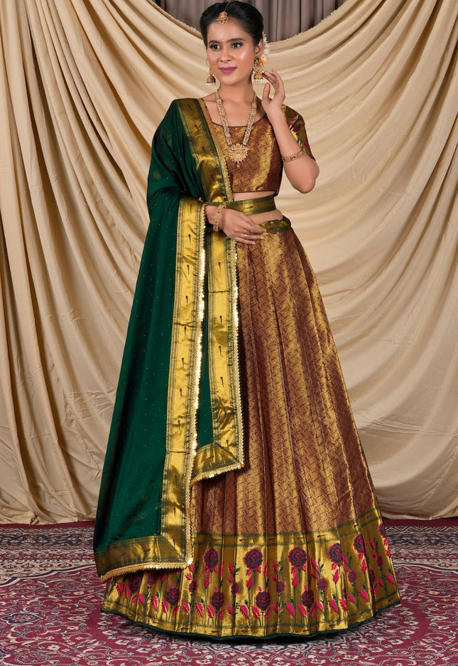 Woman wearing a traditional gold and green lehenga choli with dupatta