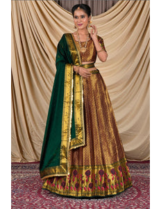 Woman wearing a traditional gold and green lehenga choli with dupatta