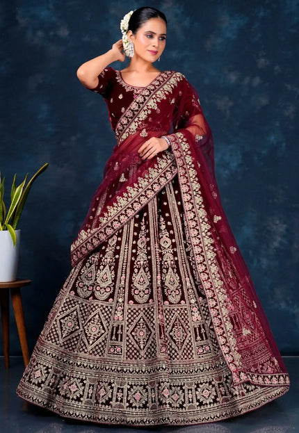 Woman wearing a maroon embroidered lehenga choli with dupatta