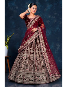 Woman wearing a maroon embroidered lehenga choli with dupatta