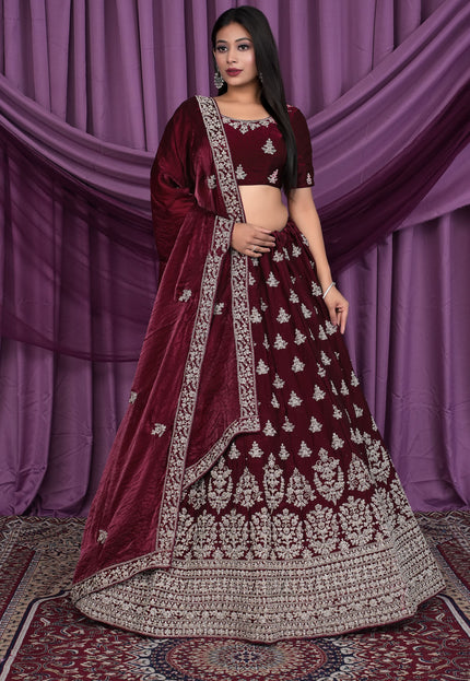 Woman wearing a maroon embroidered traditional lehenga choli
