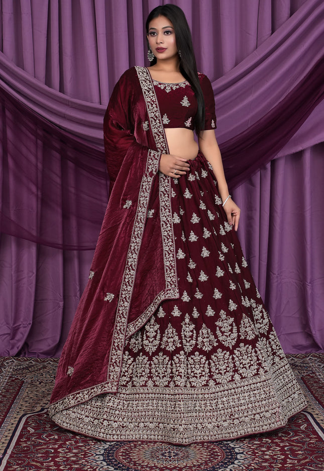 Woman wearing a maroon embroidered traditional lehenga choli
