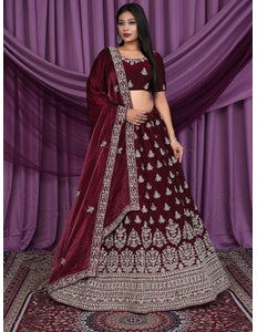Woman wearing a maroon embroidered traditional lehenga choli