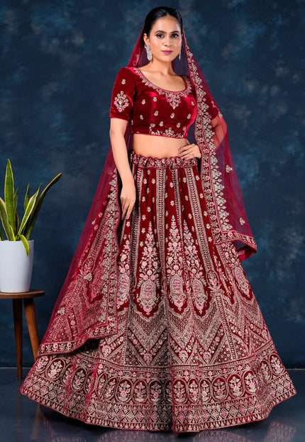 Woman wearing a traditional maroon embroidered lehenga choli with dupatta
