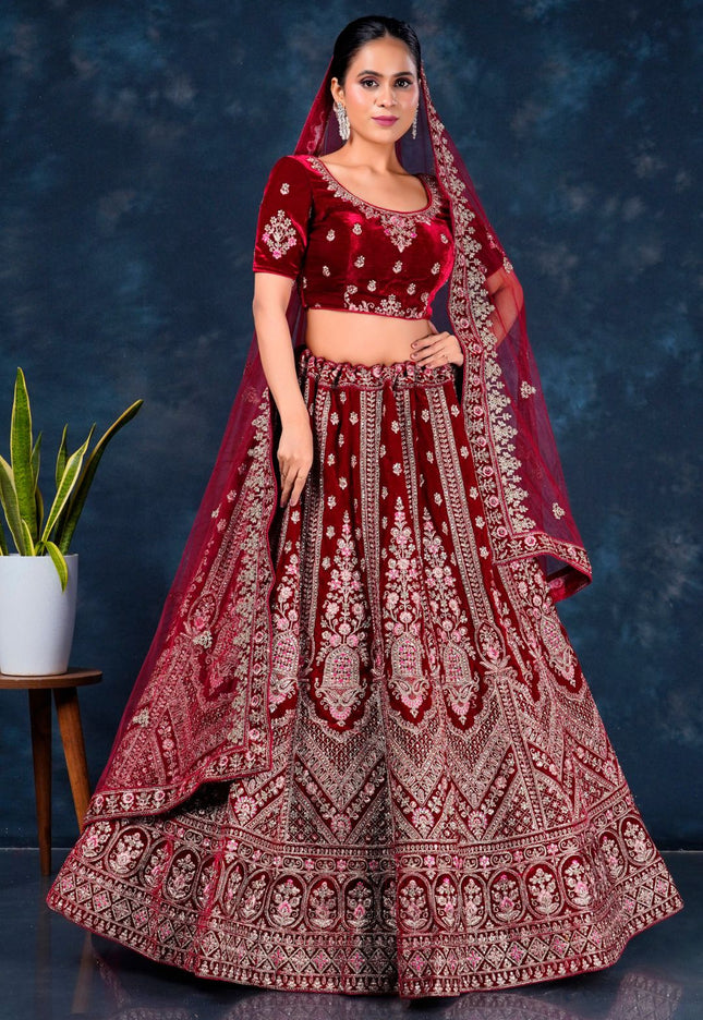 Woman wearing a traditional maroon embroidered lehenga choli with dupatta