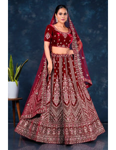 Woman wearing a traditional maroon embroidered lehenga choli with dupatta