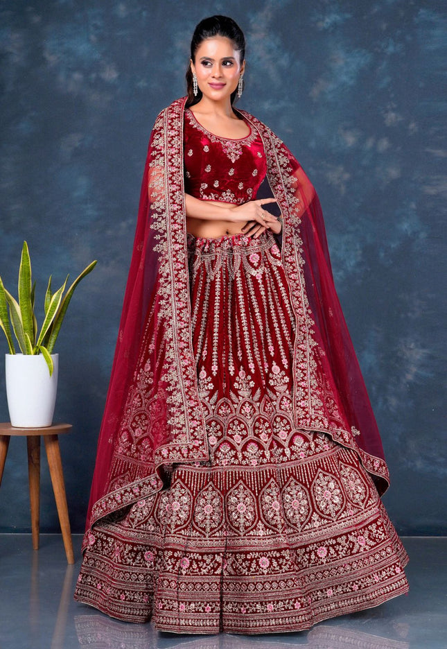 Woman in a traditional maroon embroidered lehenga choli with dupatta