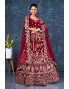 Woman in a traditional maroon embroidered lehenga choli with dupatta