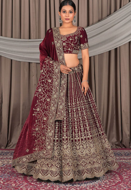 Woman in a maroon and gold traditional outfit