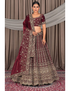 Woman in a maroon and gold traditional outfit