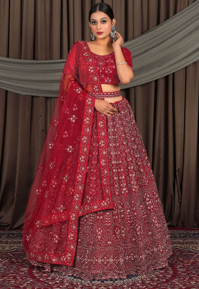 Woman in a red traditional outfit with a matching dupatta