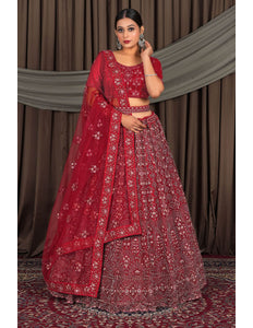 Woman in a red traditional outfit with a matching dupatta