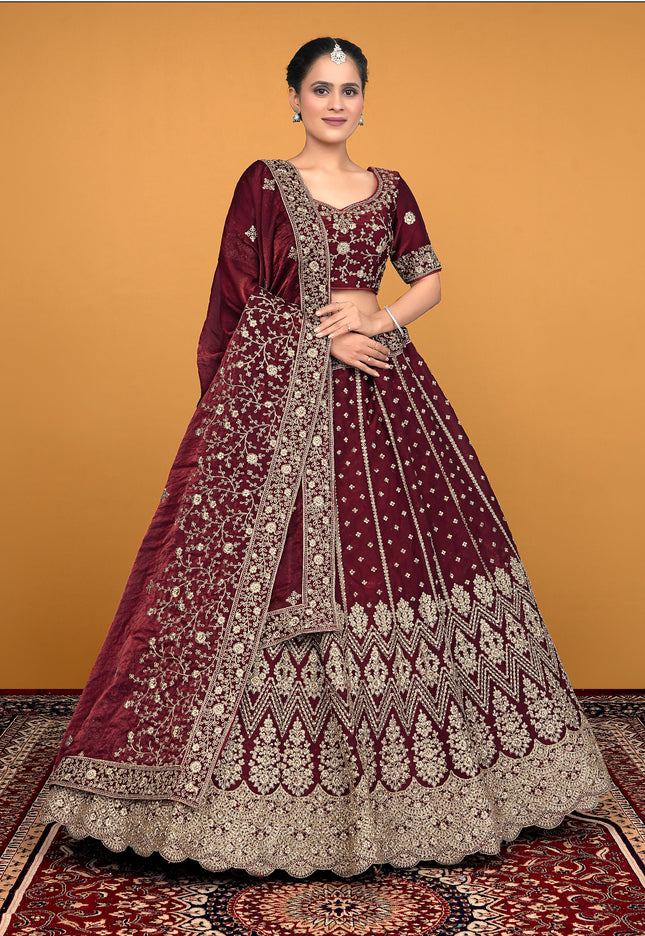 Woman wearing a maroon embroidered traditional lehenga choli