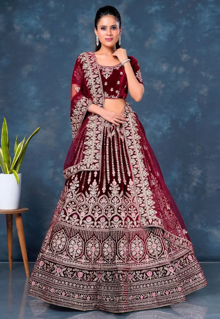 Woman wearing a maroon embroidered traditional bridal lehenga choli