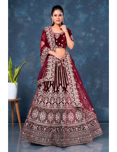 Woman wearing a maroon embroidered traditional bridal lehenga choli