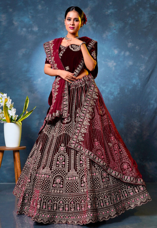Woman wearing a traditional maroon embroidered lehenga choli with dupatta
