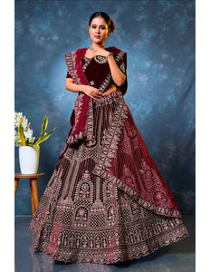 Woman wearing a traditional maroon embroidered lehenga choli with dupatta