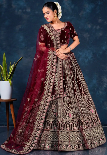 Woman in a traditional maroon embroidered lehenga choli with dupatta