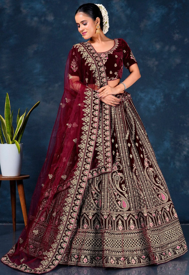 Woman in a traditional maroon embroidered lehenga choli with dupatta