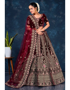 Woman in a traditional maroon embroidered lehenga choli with dupatta