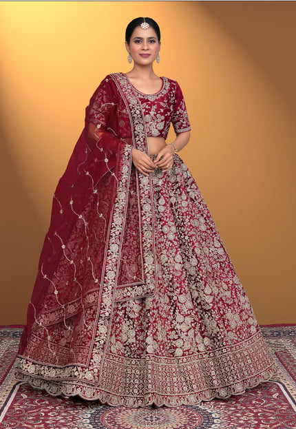 Woman wearing a traditional maroon embroidered lehenga choli
