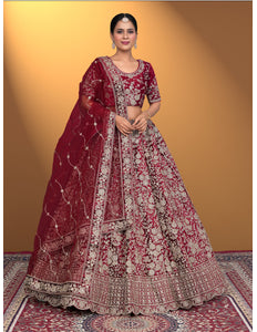 Woman wearing a traditional maroon embroidered lehenga choli