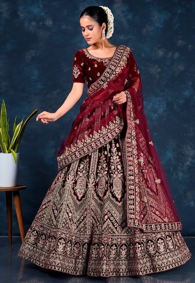 Woman in a maroon embroidered traditional lehenga choli with dupatta