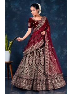 Woman in a maroon embroidered traditional lehenga choli with dupatta