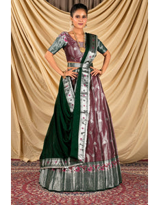 Woman wearing a traditional outfit with a green and maroon dress