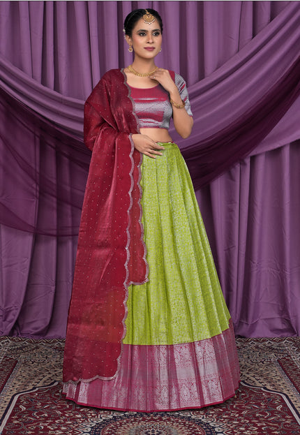 Woman wearing a green and red traditional lehenga choli