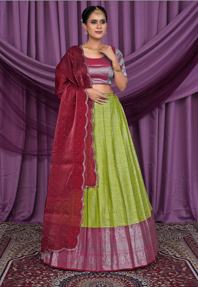 Woman wearing a green and red traditional lehenga choli
