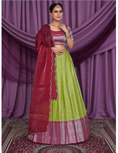 Woman wearing a green and red traditional lehenga choli