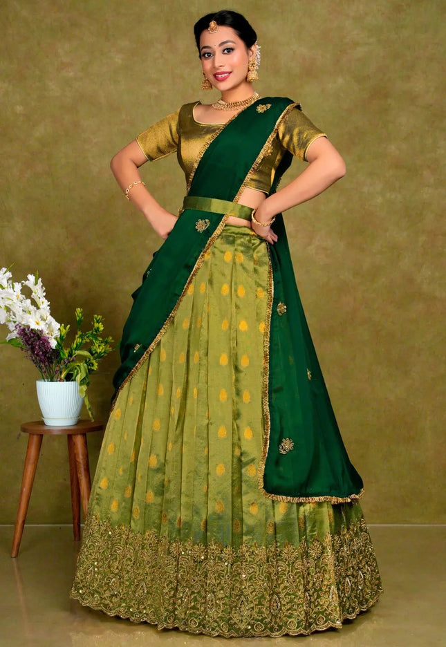 Woman wearing a green traditional outfit with a matching blouse