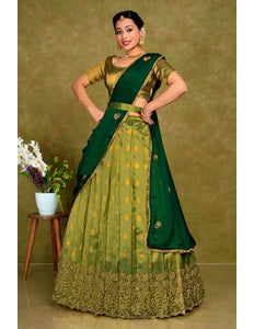 Woman wearing a green traditional outfit with a matching blouse