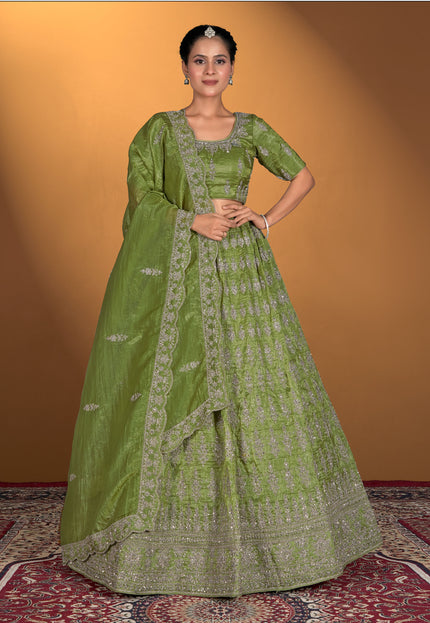Woman wearing a green traditional outfit with intricate patterns