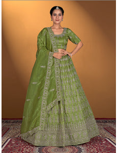 Woman wearing a green traditional outfit with intricate patterns