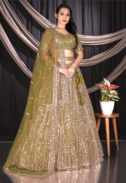 Woman in a traditional green and gold lehenga outfit