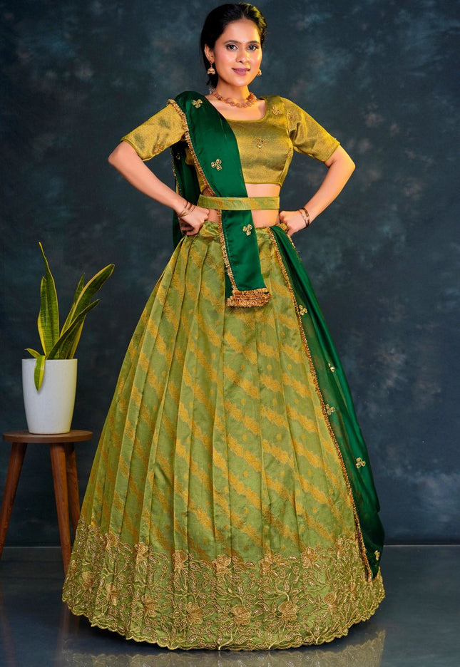 Woman wearing a green traditional outfit with a matching lehenga choli