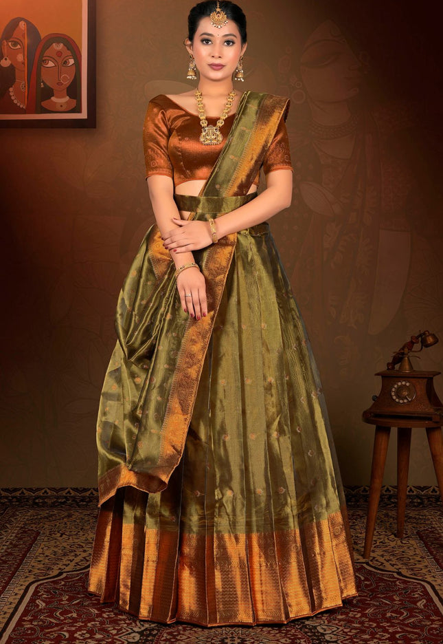 Woman in traditional green and brown lehenga choli with dupatta