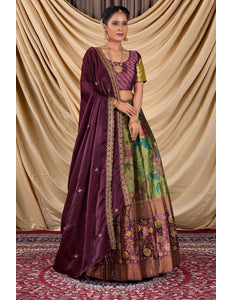 Woman wearing a traditional outfit with a purple dupatta and colorful skirt