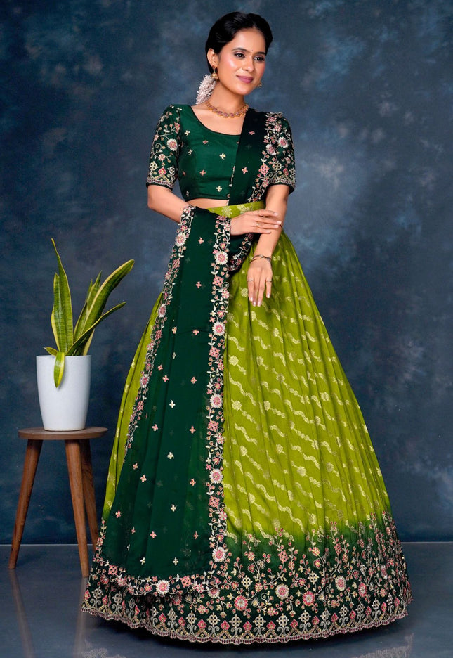 Woman wearing a green and lime green traditional outfit with floral patterns