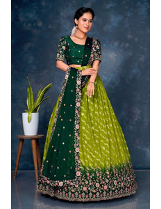 Woman wearing a green and lime green traditional outfit with floral patterns