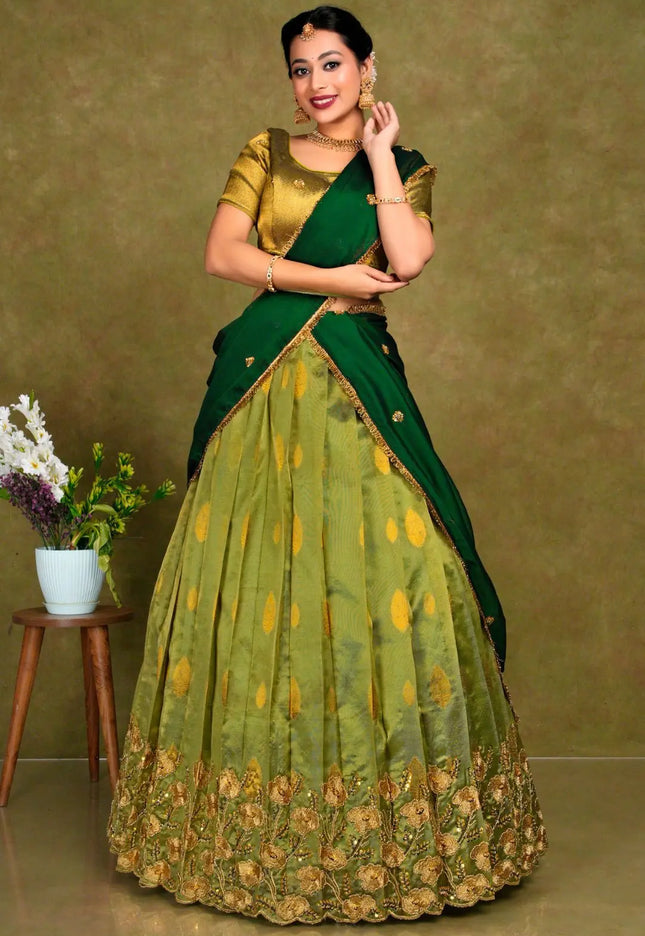 Woman wearing a green and gold traditional outfit
