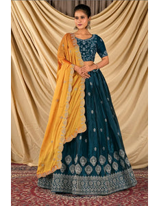 Woman wearing a traditional blue and yellow lehenga choli with dupatta