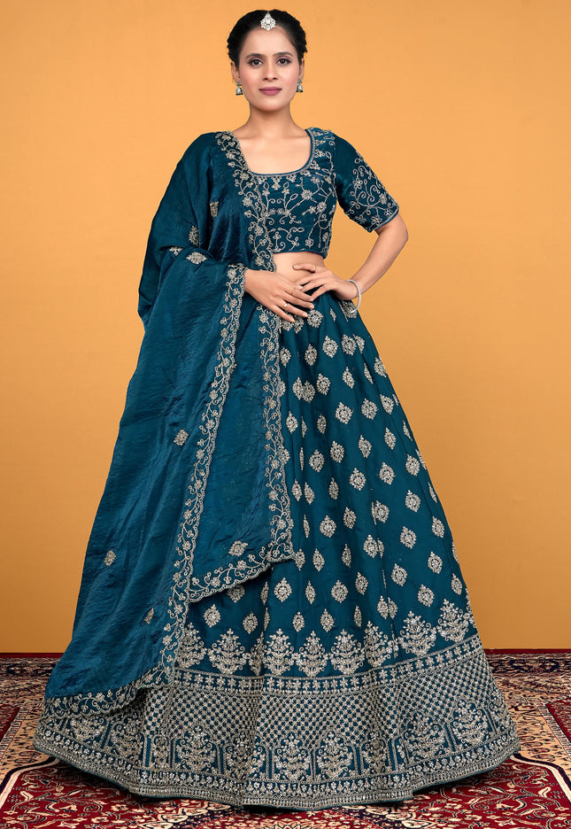 Woman wearing a traditional blue embroidered lehenga choli