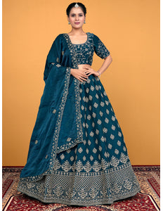 Woman wearing a traditional blue embroidered lehenga choli