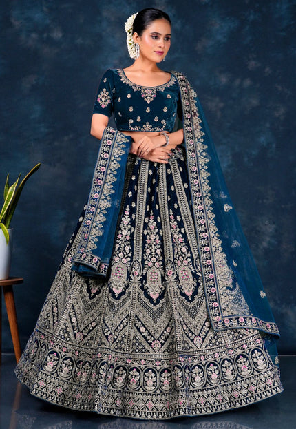 Woman in a traditional embroidered bridal lehenga choli with net dupatta