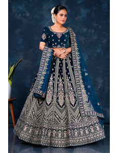 Woman in a traditional embroidered bridal lehenga choli with net dupatta
