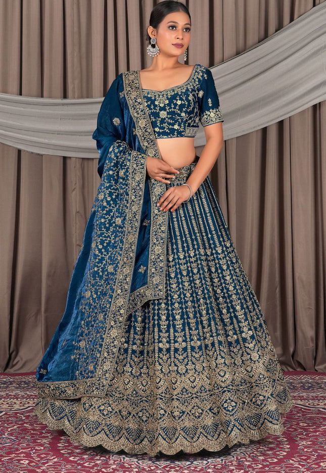 Woman wearing a blue embroidered traditional outfit